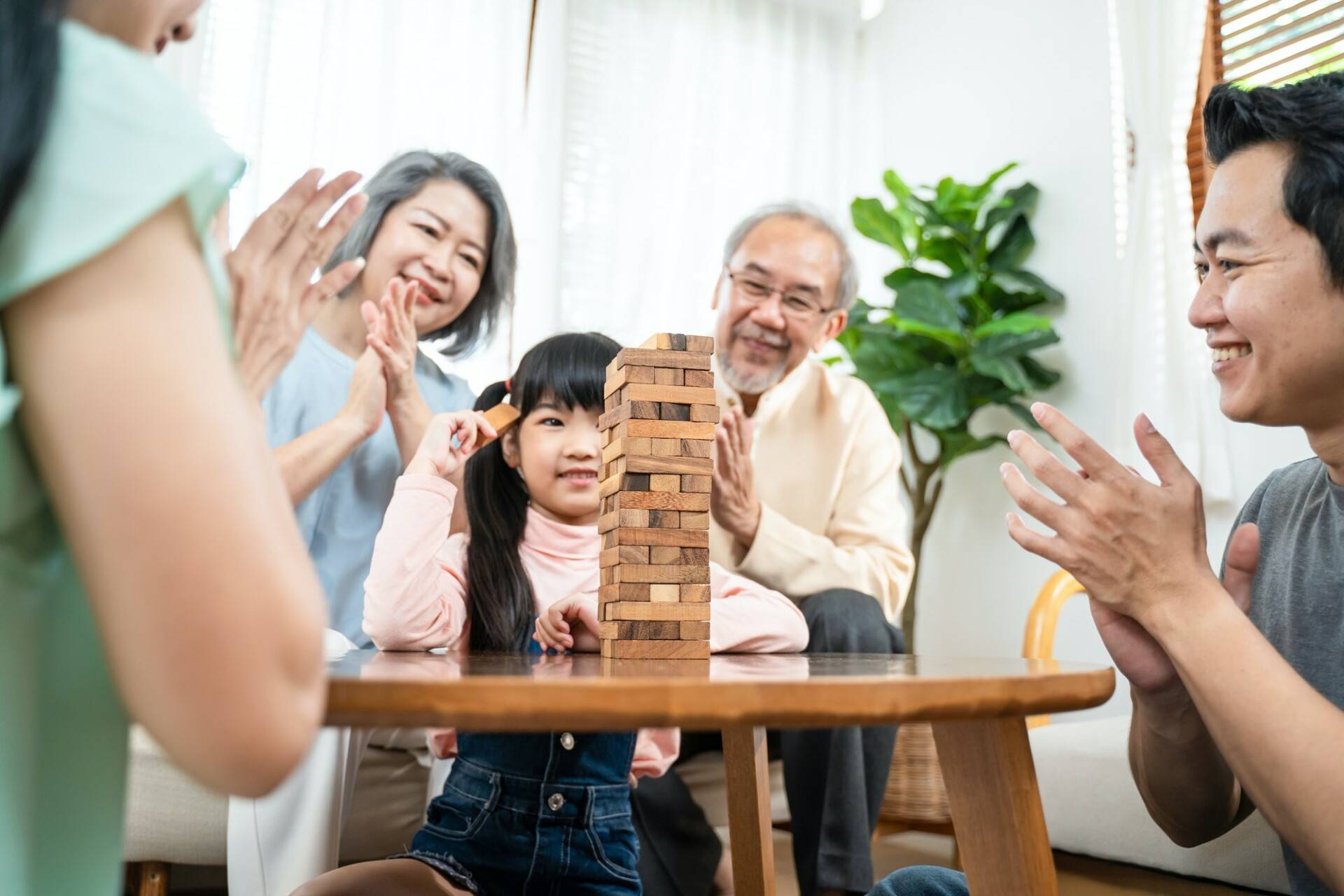 Asian family stay at home, enjoying activity relationship in living room.