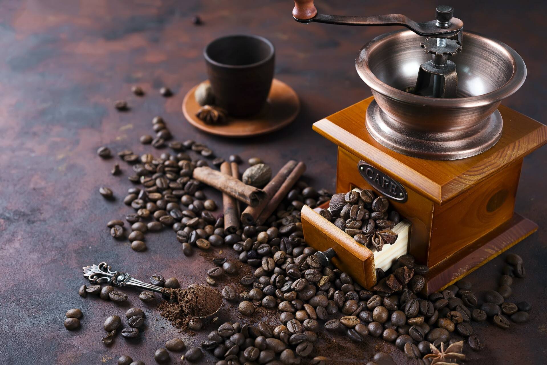 still life of coffee beans with coffee grinder